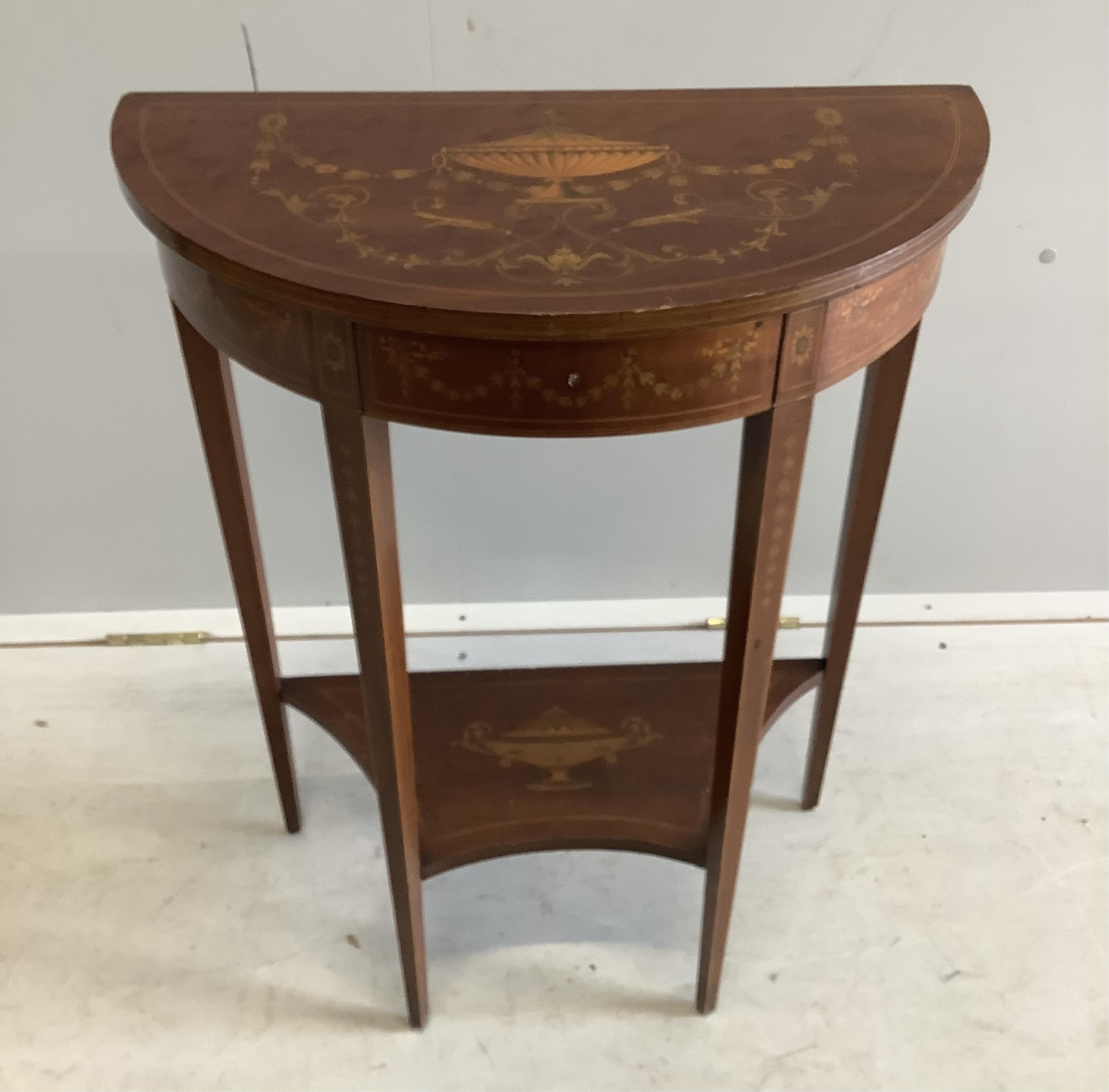 A Edwardian marquetry inlaid mahogany D shaped two tier side table in the manner of Edward & Roberts, width 57cm, depth 29cm, height 75cm. Condition - fair to good